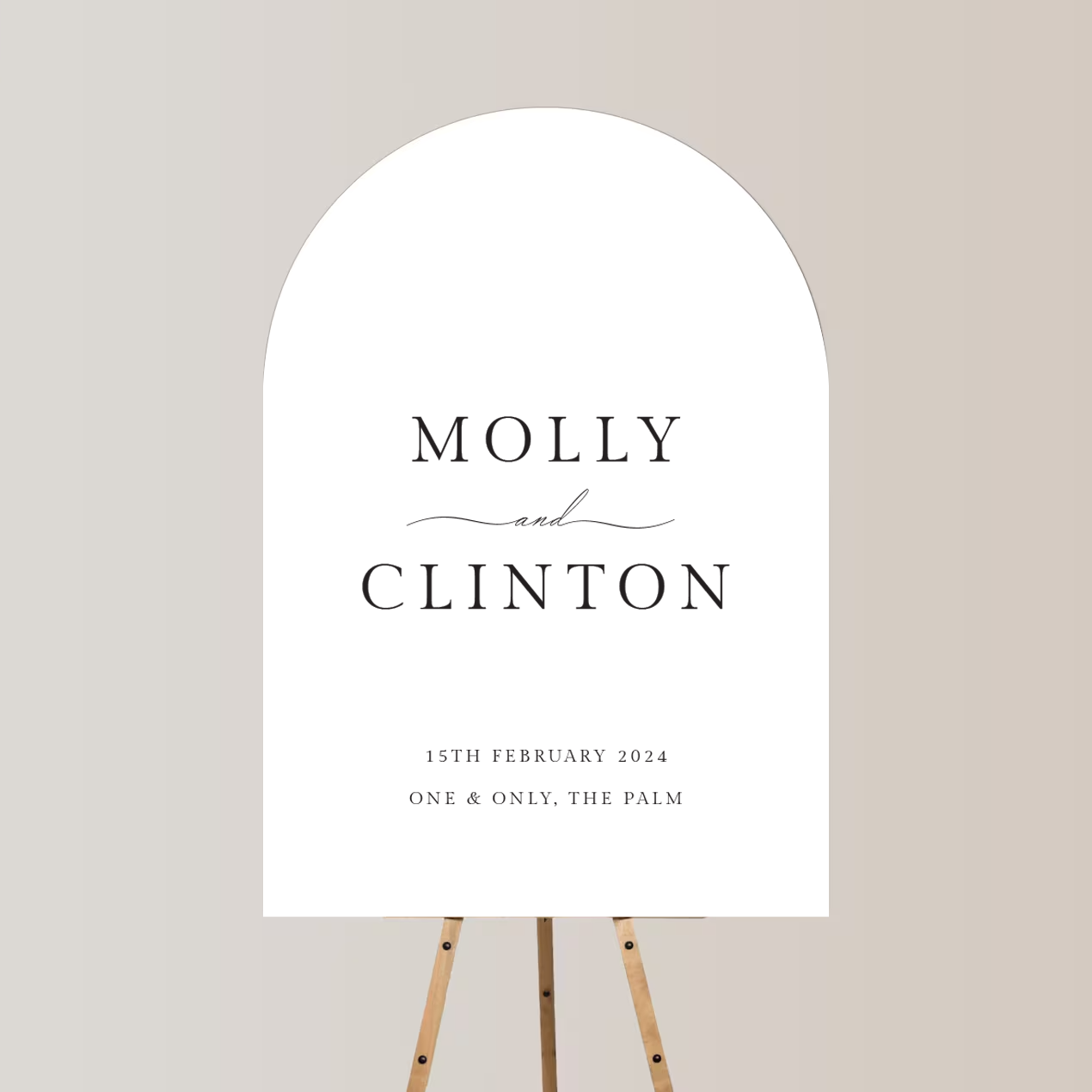Wedding invitation with elegant black text on a white arched background, standing on a wooden easel, for Molly and Clinton's wedding on February 15th, 2024, at One & Only, The Palm.
