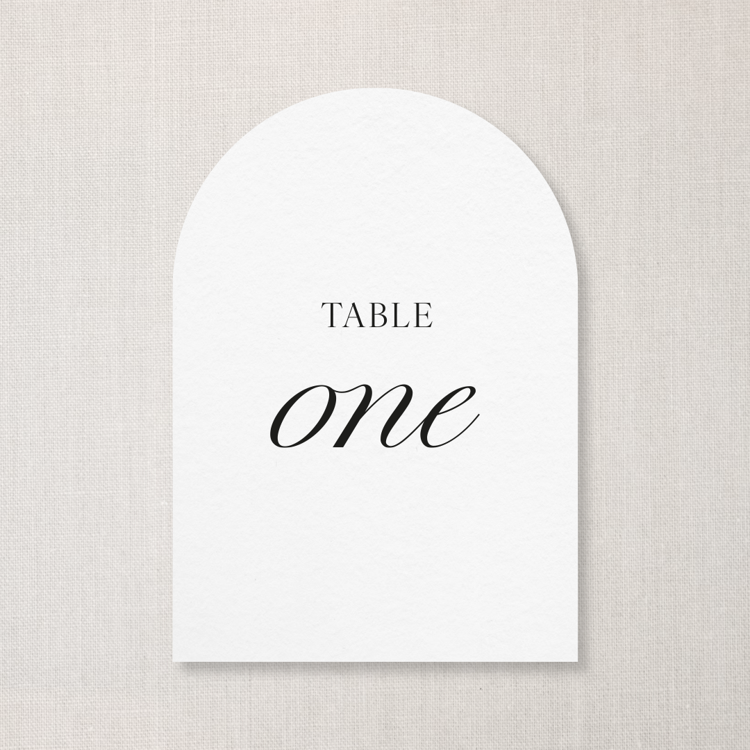 Elegant white card with black text reading "Table One" on a textured beige background.