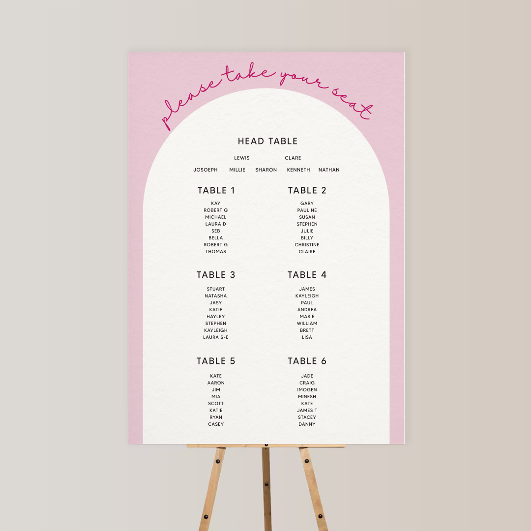 Wedding seating chart with pink and white design, titled 'please take your seat' in cursive, listing names by tables.