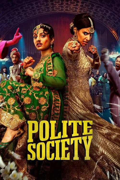Poster for the movie 'Polite Society' featuring two women in traditional Indian attire with serious expressions, pointing their fists forward, with a group of people in the background.