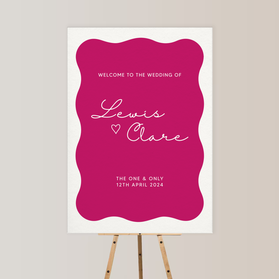 Wedding welcome sign on an easel with a pink and white background, greeting guests for Lewis and Clare's wedding on April 12, 2024.