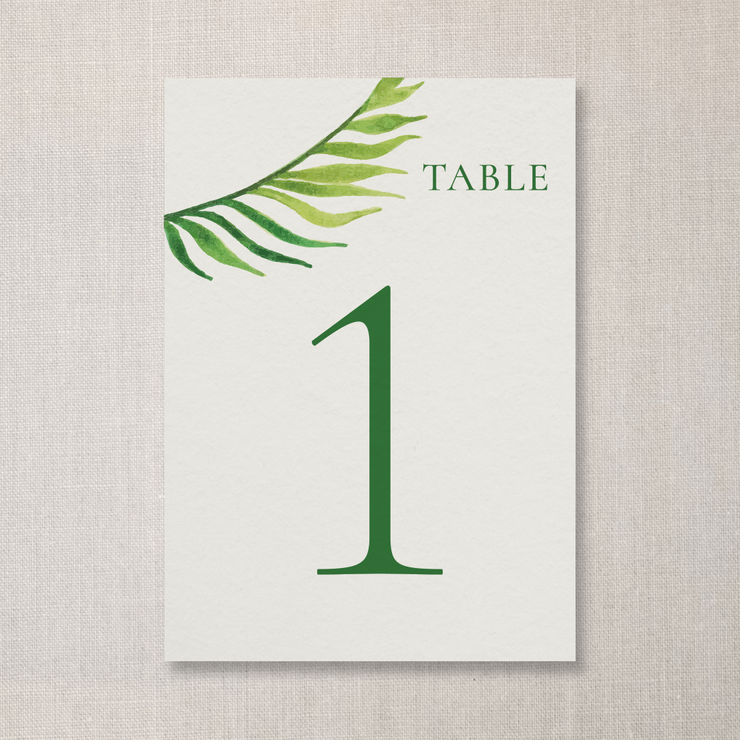 A table number card with a large green number 1 and the word 'TABLE' at the top right corner, decorated with a green watercolor palm leaf in the top left corner.