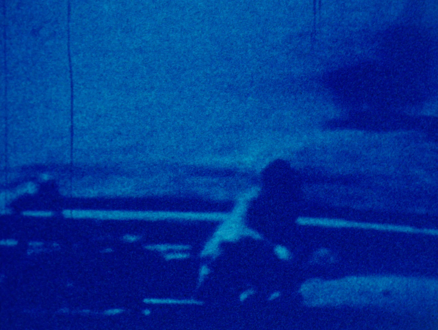 Interval (2017) Two looped HD video projections, color, silent; nineteen digital prints In 1983, I completed a film entitled 1963 (a meditation on history and violence) , which would prove to be my last circulating analog work. Made twenty years after the assassination of President John F. Kennedy, 1963 was meant to be a contemplative investigation of the relation between image and memory, and indeed image as a medium that obscures memory as much as preserving or transmitting it. The paradox here is that the more traumatic the historical event, the more images and documents proliferate around it, clouding or fogging the experience to such an extent that one only sees the obscuring haze. Moreover, that haze fills the space around and between us to the extent that we no longer see one another and communicate historical experience directly. Support for the polis is no longer intersubjectivity and attention to others, but rather our blind attempts to navigate the information fog that surrounds and separates us. The source material for 1963 was a copy of Abraham Zapruder’s 8mm footage of the Kennedy assassination, itself filmed in color Super-8 off of the screen of a small black and white video monitor as it was broadcast on national television. Already twice mediated, this 26.6 seconds of images was then blown up to 16mm and step printed at one frame a second, slowing and obscuring the image while bringing forward the textures of its electronic and photochemical mediations. In 1963 , the step-printed sequence is repeated once—history repeats itself, at least in images. Kennedy’s 100th birthday took place on 29 May 2017, and we are now more than fifty years past the traumatic year of 1963. In the intervals of time that have now past between and beyond 1963 and 1983, I have often thought about returning to these materials, but in expanded form and using digital means. Interval is thus a new iteration of my ongoing interest in the fading of memory and historical experience as a function of image and medium. My intuition here is that the mediated images that comprise our collective memory of historical events are subject in complex ways to temporal erosion, where duration becomes distended and elliptical, gapped and perforated, and space is clouded by a thickening or sedimentation of time perceived as indistinct layerings of the past and the present in uneven rhythms. One anchor for the installation is a large format print of FBI exhibit K51, Abraham Zapruder’s Model 414 PD Bell & Howell Zoomatic Director Series 8mm Camera, now held in the United States National Archives. The so-called “Zapruder film” comprises 26.6 seconds of images, or 486 frames, exposed at 18.3 frames/second on Kodachrome II safety film, shot from Zapruder’s vantage point on a concrete pedestal along Elm Street in Dealey Plaza. In the context of the installation, this rather prosaic document will serve as a monogram of historical time buried within an archival document. Investigating these facts about time and timing are the conceptual motors for the general structure of Interval . Eighteen prints aligned in a continuous series on the gallery walls comprise the second element of the installation. Each individual print is an image sampled from 1963 by dividing the running time of the work by a factor of 18. The prints should all be of equal size and dimension, and set equidistant from each other; their deployment in series recalls the unrolling of a strip of film, and their uneven textures and monochrome color are reminiscent of Warhol’s “Disaster Series.” Ideally, the prints will be hung at a height approximating Zapruder’s own eye-level. Two video projections are set at either end of the print series. The time structure and duration of these works are very different. One is built from what I call a “time pyramid,” wherein a baseline image extracted from 1963 is copied, retimed at different durations, and stacked vertically on the editing timeline in different opacities. The effect of layering. different intervals of the image one on top of the other suggests that a heterogeneous and a-rhythmic time is itself obscuring the image. Layers loop and retrogress, preventing actions from going forward while splitting, fraying, and dissolving space as if to introduce new contingencies into the event, which nonetheless arrives at its foreordained conclusion. The second projection ideally will be set off from the rest of Interval in a quiet and darkened space. If the print series suggests an imagined external view point and a linear though gapped trajectory in time, and if the first video presents a compression of historical time into densely packed heterogeneous series, the second video offers and impossibly elongated event, slowed to the point of indiscernibility. The space of the second projection is meant to give the impression of residing within our own heads, or some solitary space disconnected from the outer world. This should be a floor-to-ceiling projection. Its material comprises a digitized file of the super-8 source images for 1963 , retimed to a duration of 55 minutes—the exact time elapsed between the landing of Air Force Two at Love Field in Dallas and the firing of the first shot in Dealey Plaza. For viewers unwilling to spend significant time in this meditative space, the images will appear almost completely still, or moving forward at a rate just below the capabilities of human perception. A central theme of Interval concerns the technological conveyance of historical experience through images in uneven rhythms and staggered durations where information is both elliptical and gapped, and either too present or too withdrawn. In this respect, it should be said that at no point is the image of Kennedy’s assassination visible in the installation materials. It therefore functions as something like a structuring absence, or the unbearable punctum or traumatic puncture in history that can never be recovered or brought again to sight.
