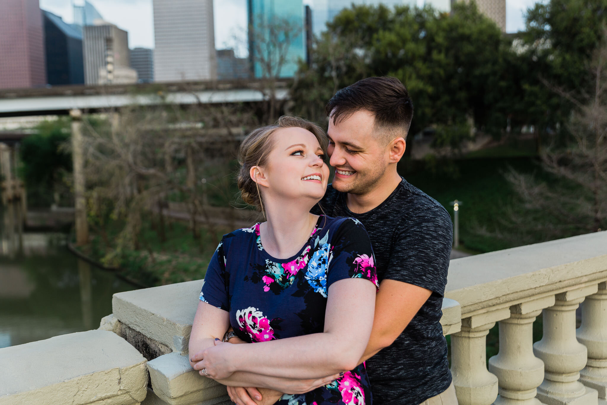 couple posing on bridge hugging