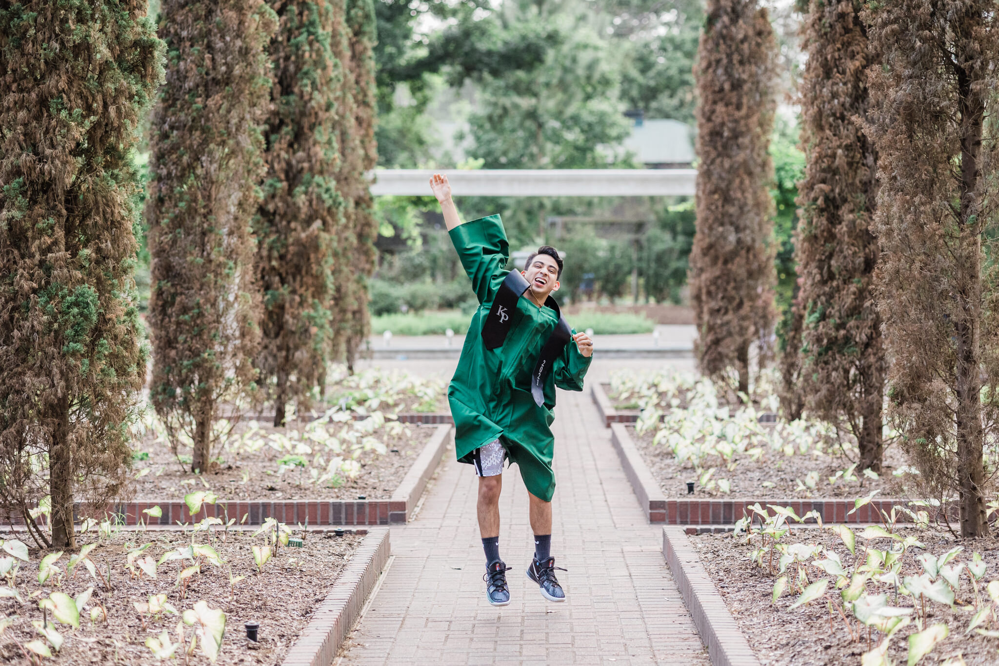 senior robe jumping for joy