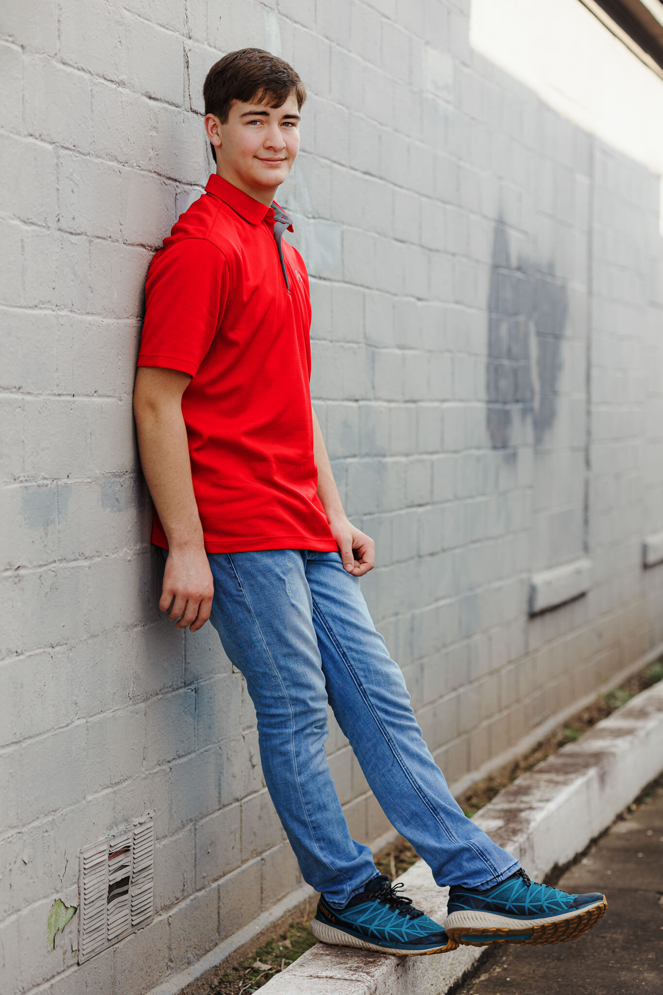 senior male red polo wall full body