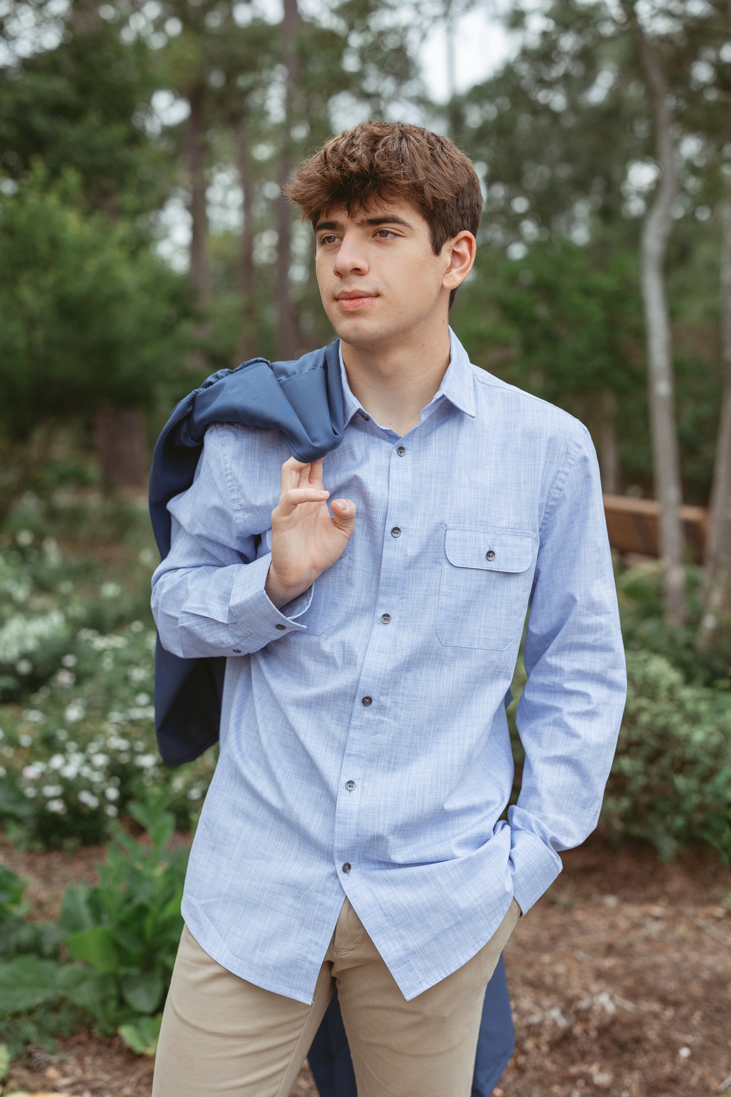 senior male portrait dress shirt outdoors gown over shoulder