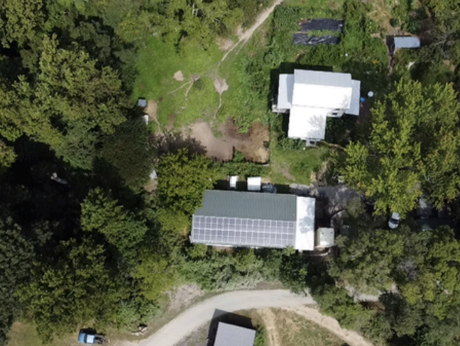 Drone view of Black Trumpet Farm with newly installed solar panels on roof.