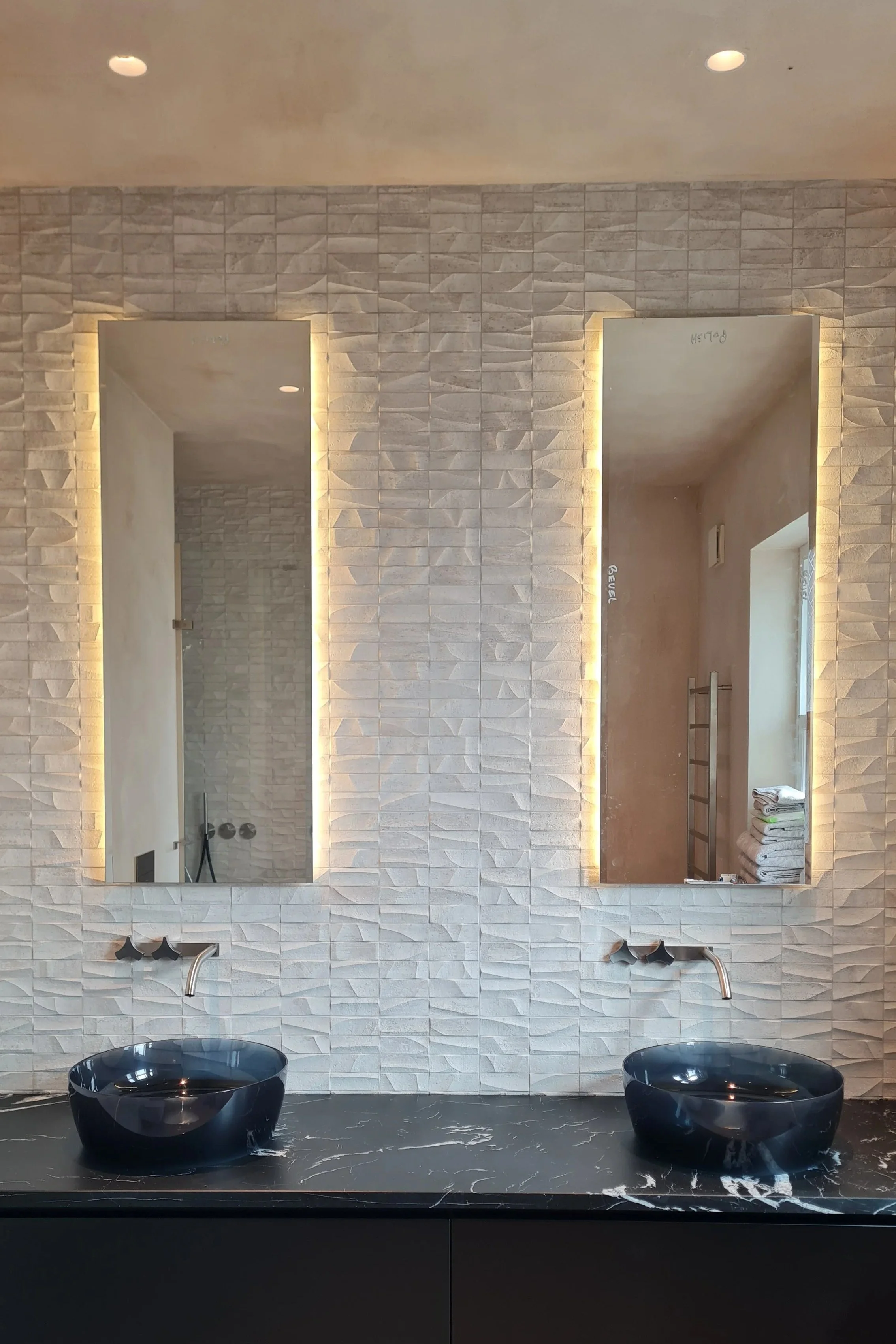 Luxury modern bathroom design featuring natural textured wall and Italian architectural fittings in Barnes, London, SW13.