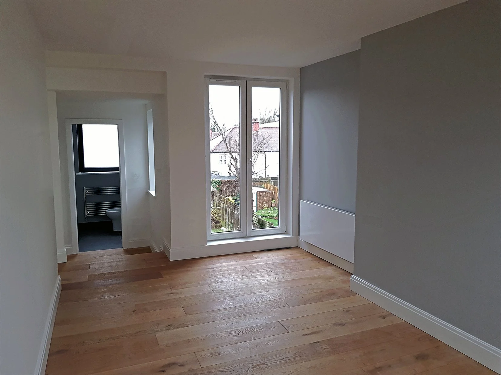 Loft conversion primary bedroom with juliet balcony in Ealing London