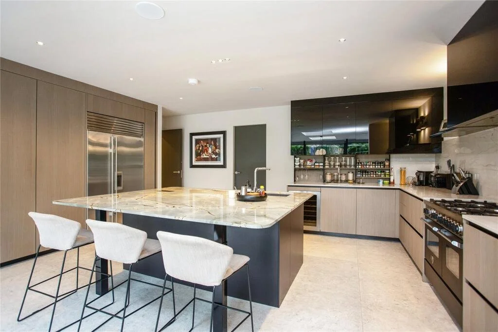 Bespoke contemporary kitchen island and dining area in a new-build Surrey home.