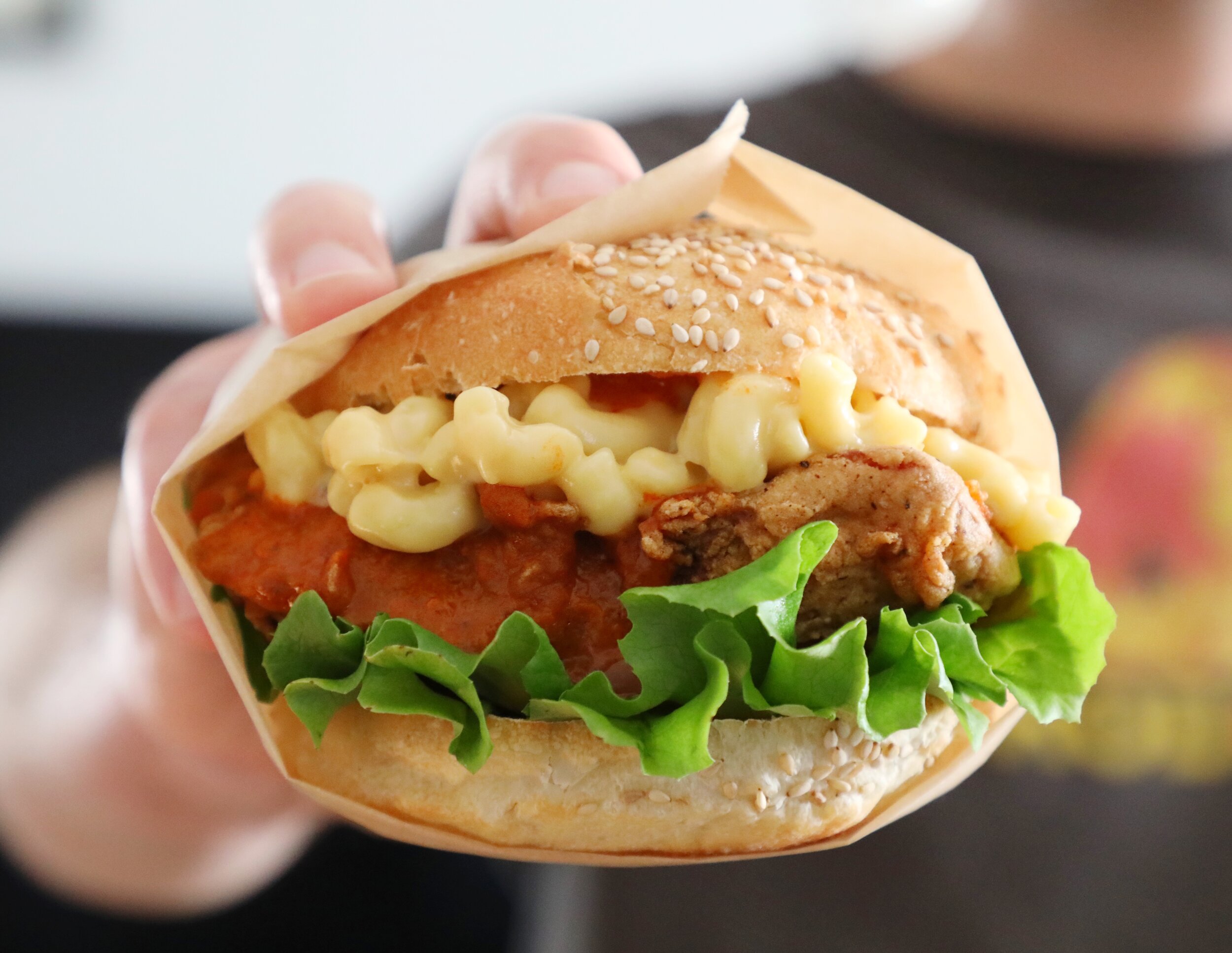 Buffalo Mac &amp; Chicky: double battered housemade fried seitan smothered in buffalo sauce and topped with our own cheezy mac and cheeze, lettuce, and tomato on a toasted local sesame roll.