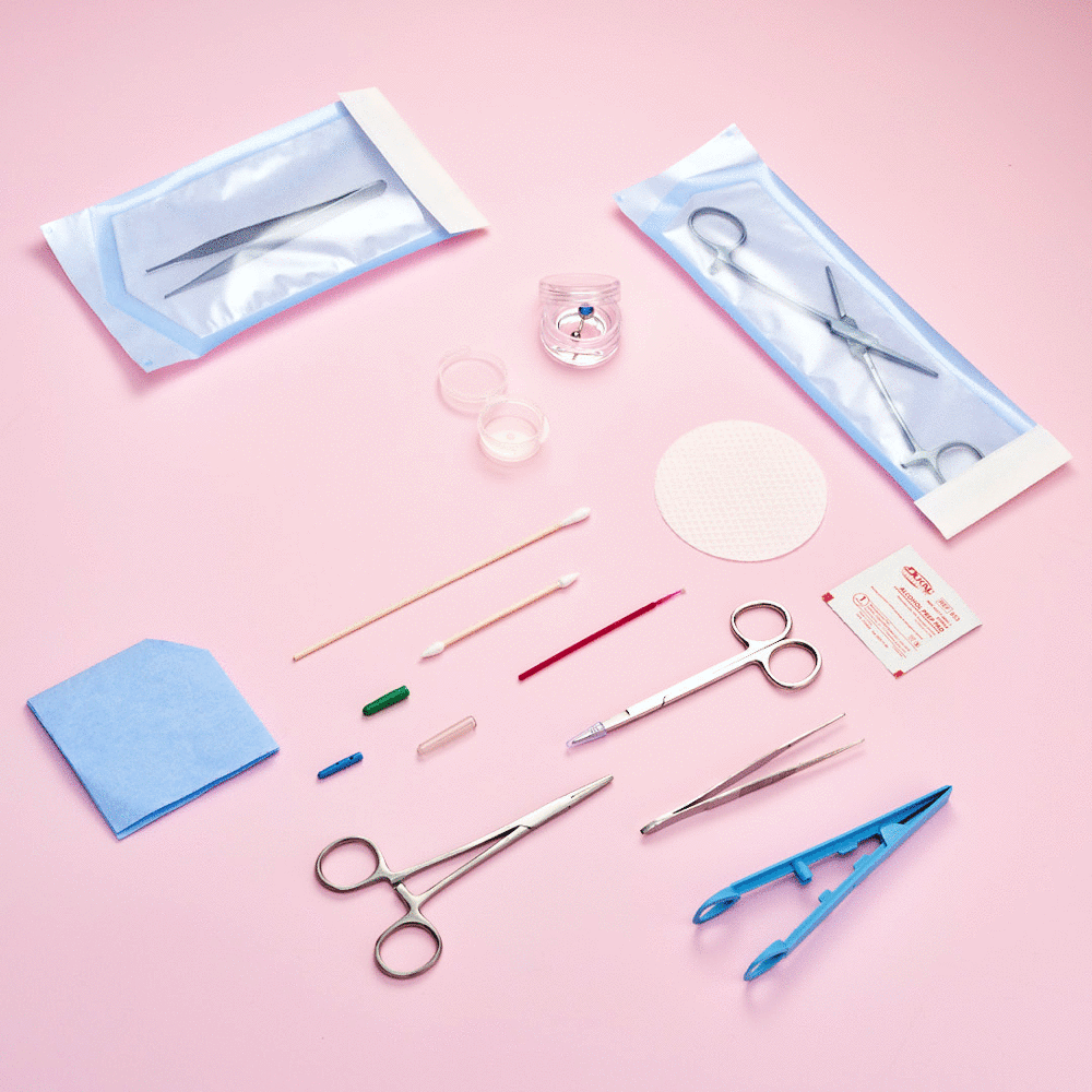 Medical surgical instruments and supplies on a pink background including scissors, tweezers, swabs, antiseptic wipes, and other sterile tools.