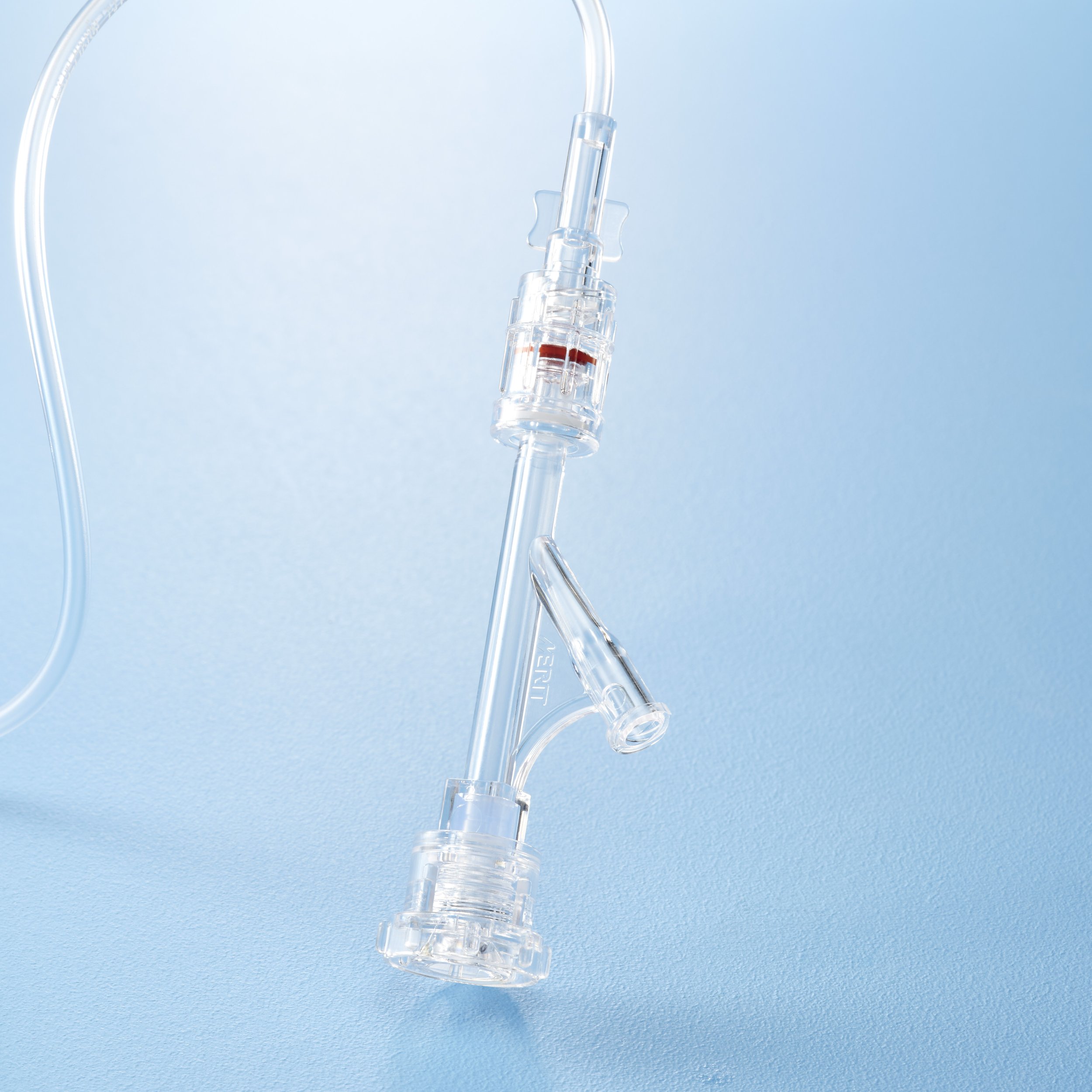 Medical intravenous (IV) tubing set with a connection port, against a blue background.