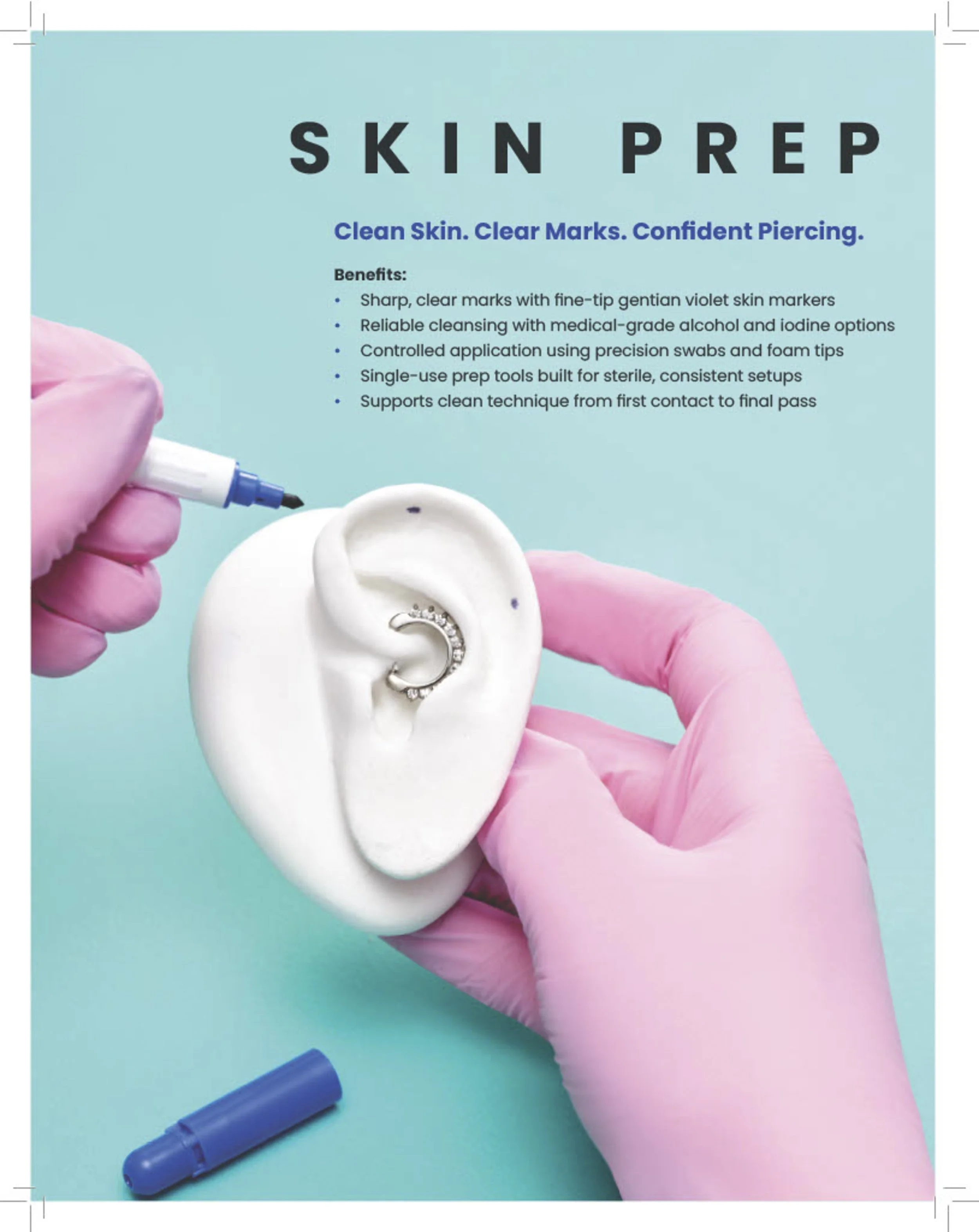 A person wearing pink gloves holds a silicone ear model with a small hoop earring inside. The person is about to mark the ear with a black pen, demonstrating a piercing process. The background is aqua blue with text describing skin prep for piercings