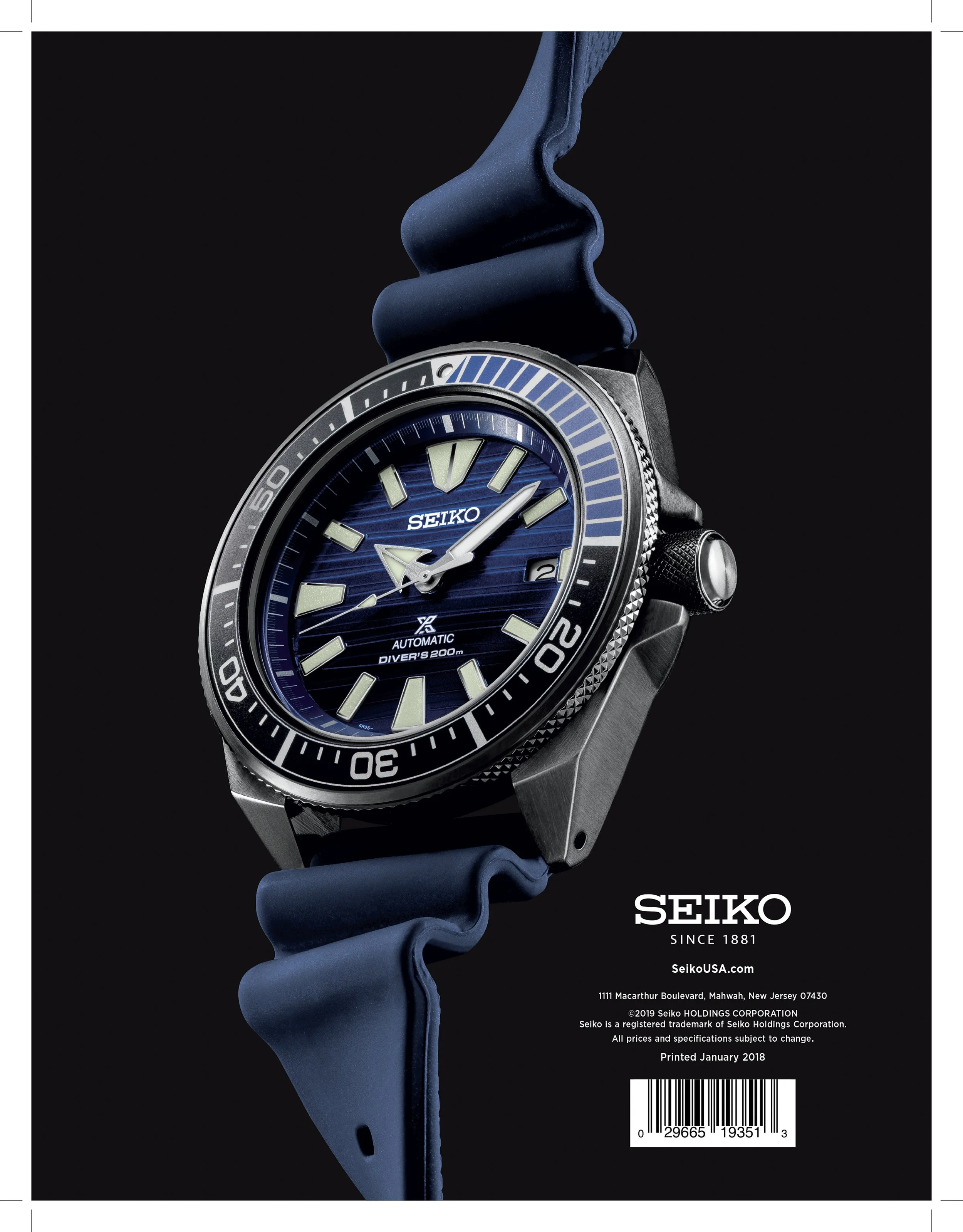 Close-up of a Seiko diver's watch with a blue dial, black and silver bezel, and blue strap, set against a black background.