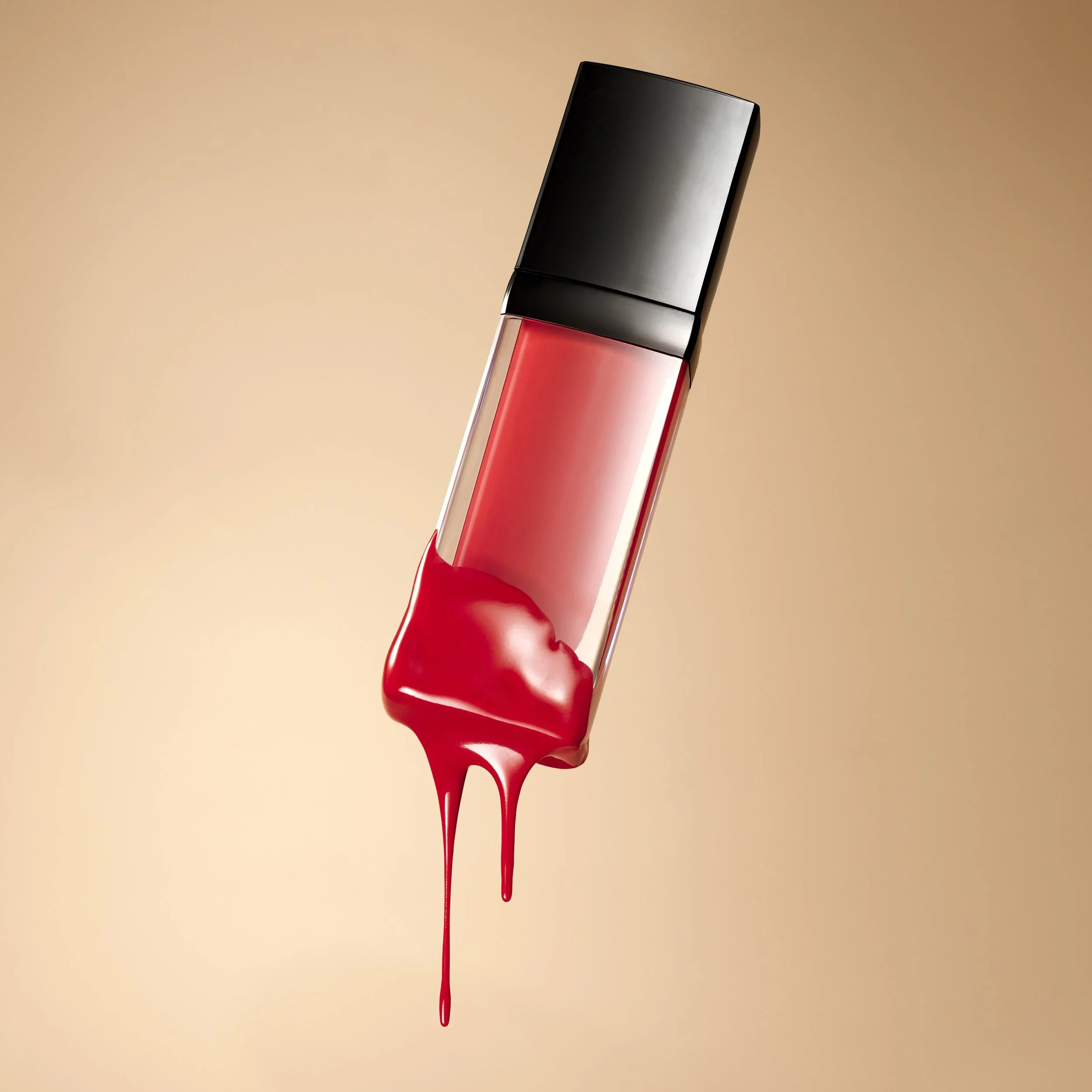 A lipstick tube with red lipstick melting and dripping down.