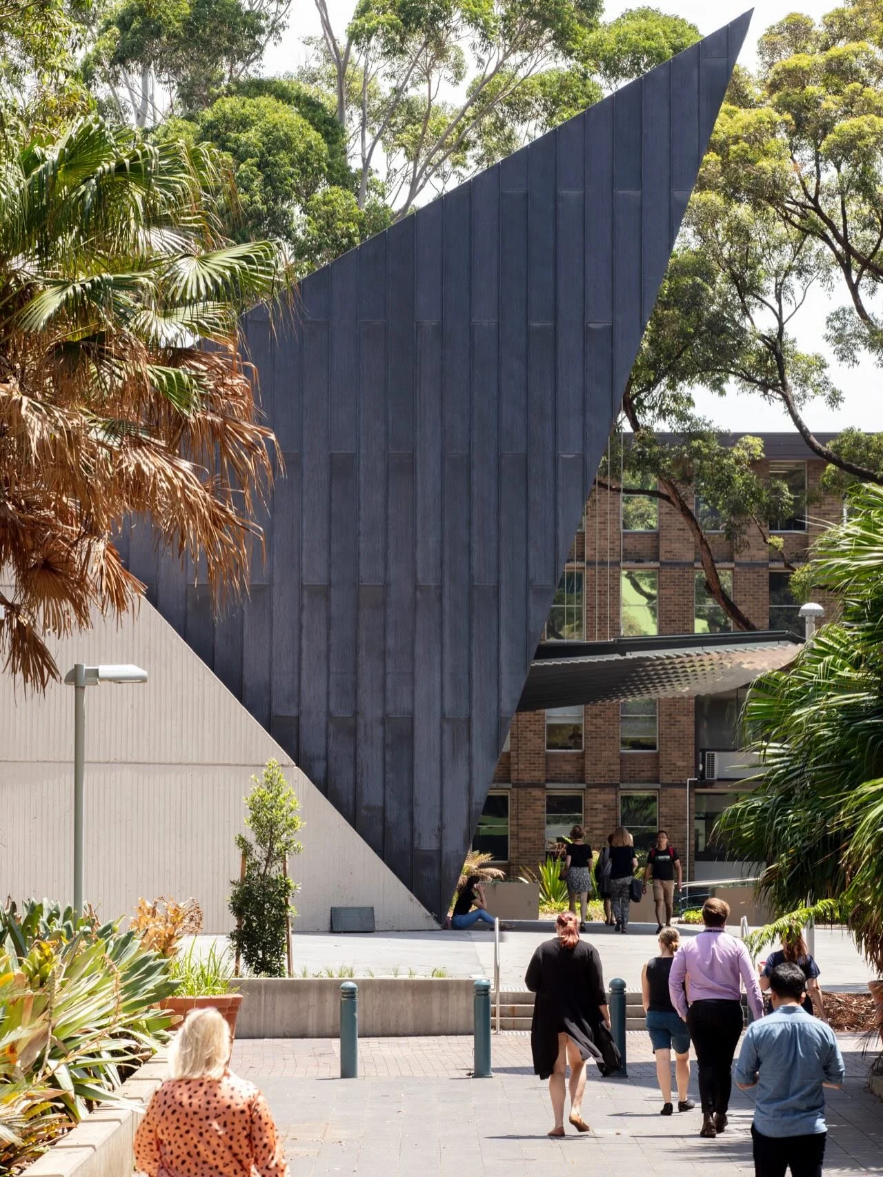 people in our places.

Located on Bedegal Land, the Sir John Clancy Auditorium acts as a &lsquo;front door&rsquo;, welcoming people to @unsw &rsquo;s upper campus in Kensington.

The triangular form of the expanded main northern foyer is a simple res