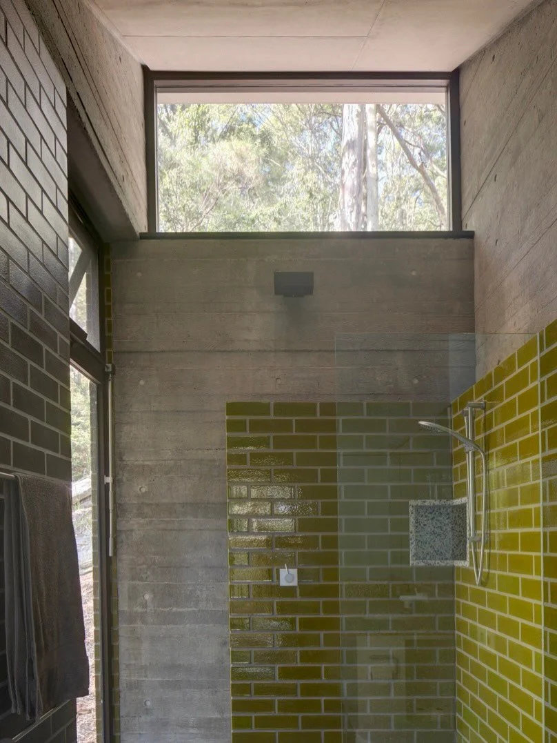 Pretty Beach House is built for long weekends.

Perched on a steep bush site within Darkinjung Country, every aspect of the house reinforces its position high amongst the trees.

The robust palette of low maintenance, bushfire resistant materials is 