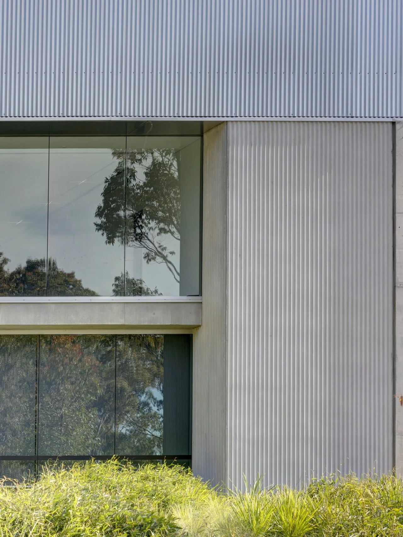 materials in mind.

Located on Bidjigal Country, Powerhouse Castle Hill finds its character in a minimalistic palette that celebrates raw, industrial materiality.

Corrugated metal cladding on the upper facade sits directly atop a precast corrugated 