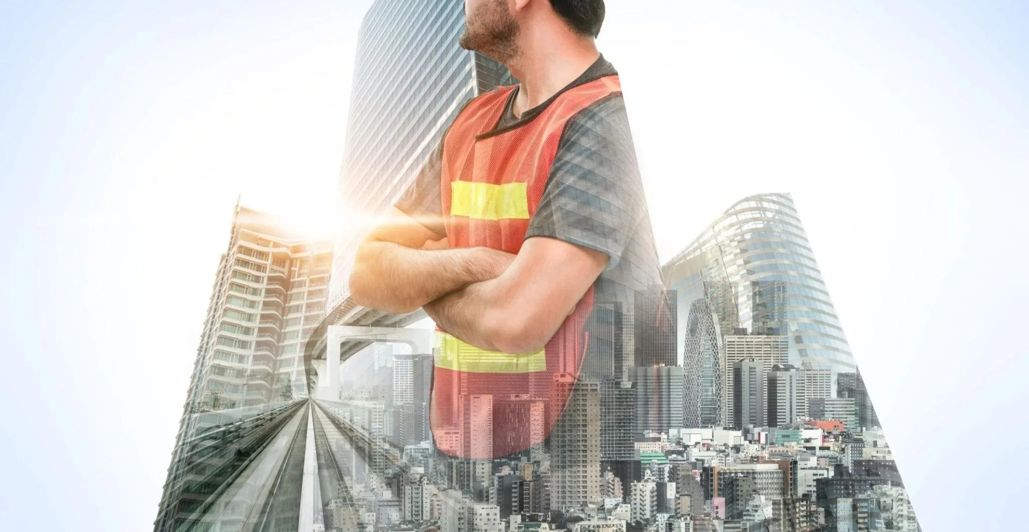 A man in a construction vest stands with his arms crossed, superimposed over a cityscape with modern skyscrapers and a monorail track, with sunlight shining behind him.