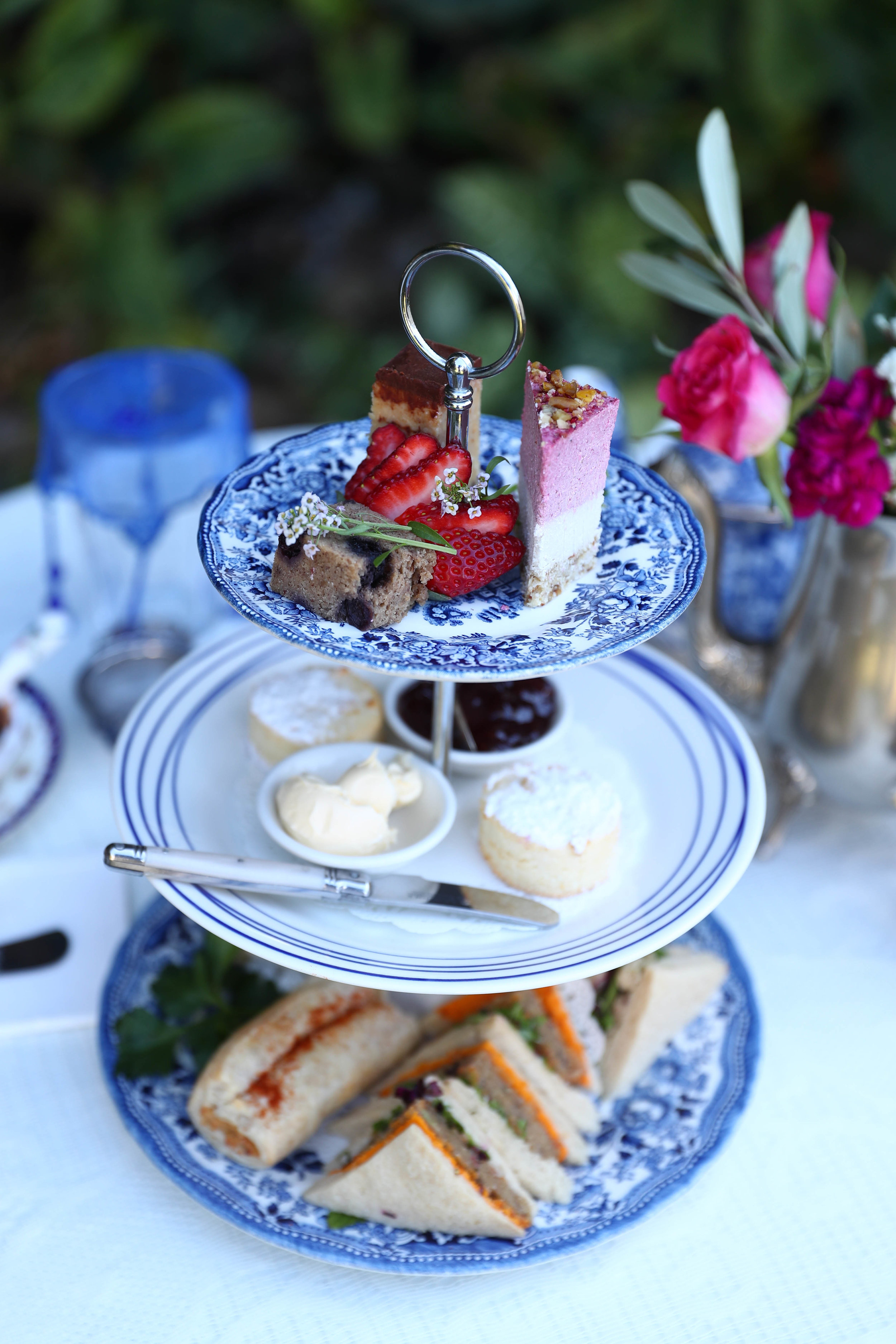 Gluten-free coconut scones served fresh from the oven with vegan cream and fruit preserve