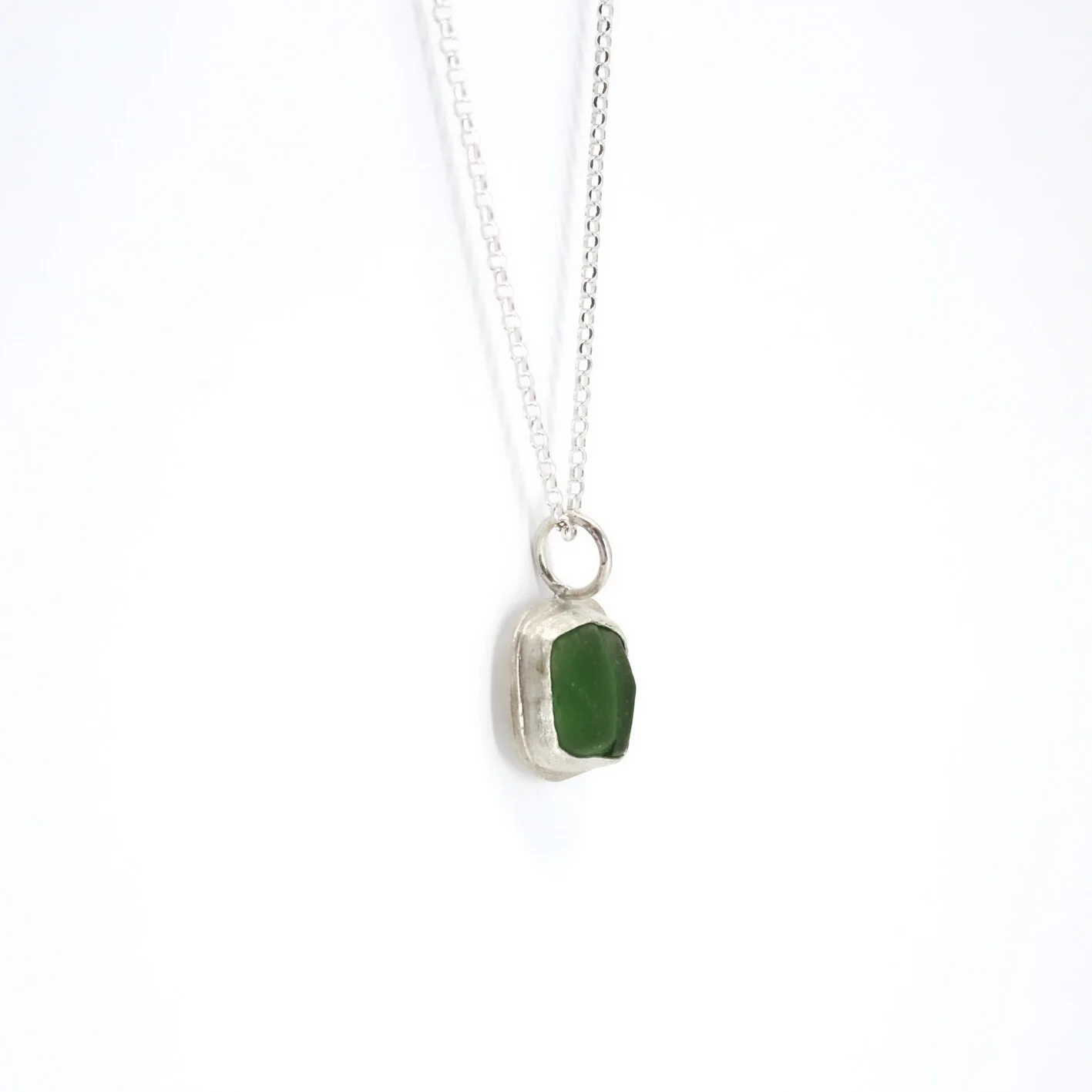 bean shaped dark green sea glass 