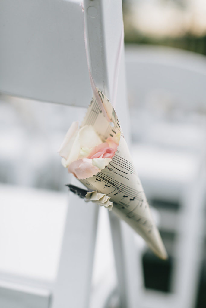 This bride made funnels out of music sheets to hold the petals for guests to throw at them!