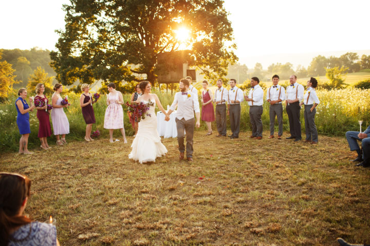 They were able to have the ceremony in the field like they wanted. After rehearsal the night before, they had someone come out and mow the area for the ceremony. The treehouse the bride used to play in was in the background. This was very special to her. Photo by The Wiebners.