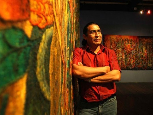 Maximo-Laura-with-his-tapestries-573x400.jpg