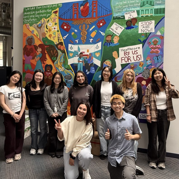 A group photo of AHEC Scholars in front of a mural. Click the image to be taken to the AHEC Scholars Statewide Application