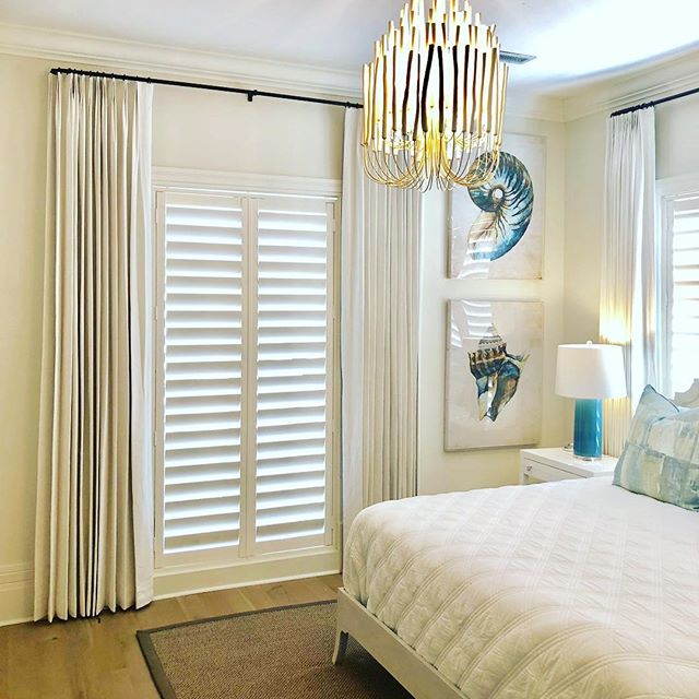 Layers of plantation shutters and tailored panels can warm up any decor.