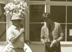 Peter Goodwin (with flowers growing out of his hat) gives Jim Colchester his pruning saw