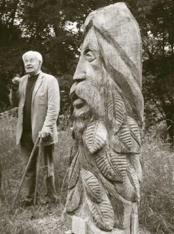 John stands beside his sculpture "The Spirit of the Woods". (Phil Hinton)
