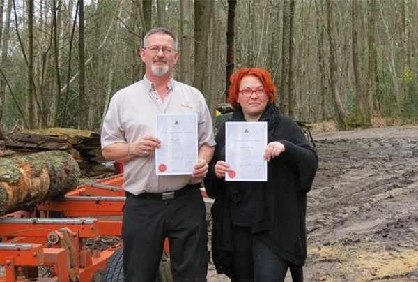 David Biggs, General Manager, Wood-Mizer UK and Liza Niedduof Artizans of Wood with their certificates of membership of Woodland Heritage