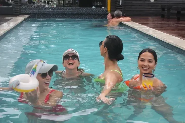 Guests relaxing in the pool at PUR Boutique Cabanas