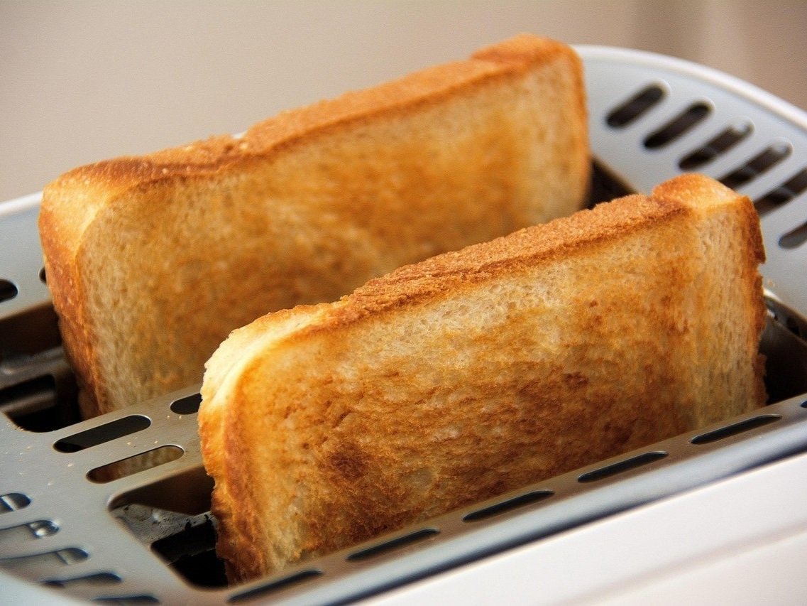 Two slices of toasted bread in a toaster