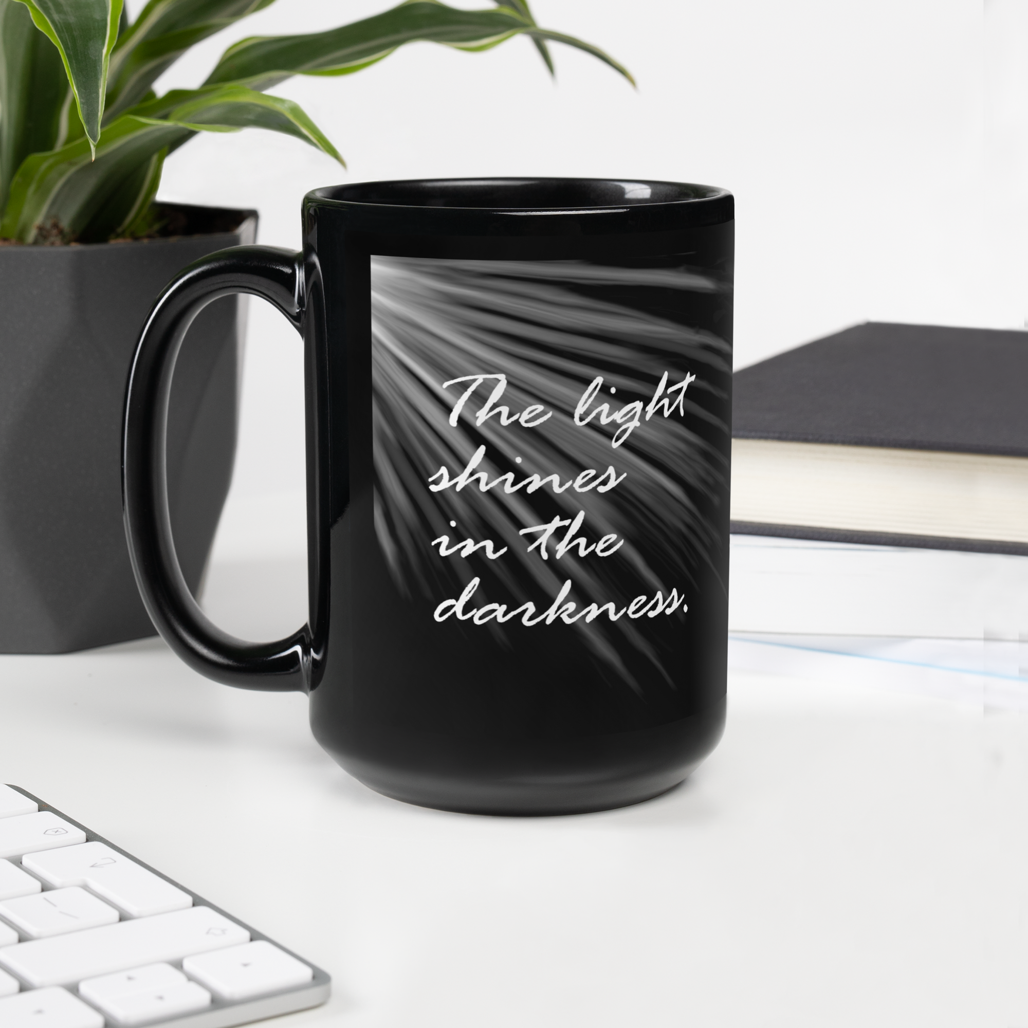 "The light shines..." black glossy mug, left-hand sunrays