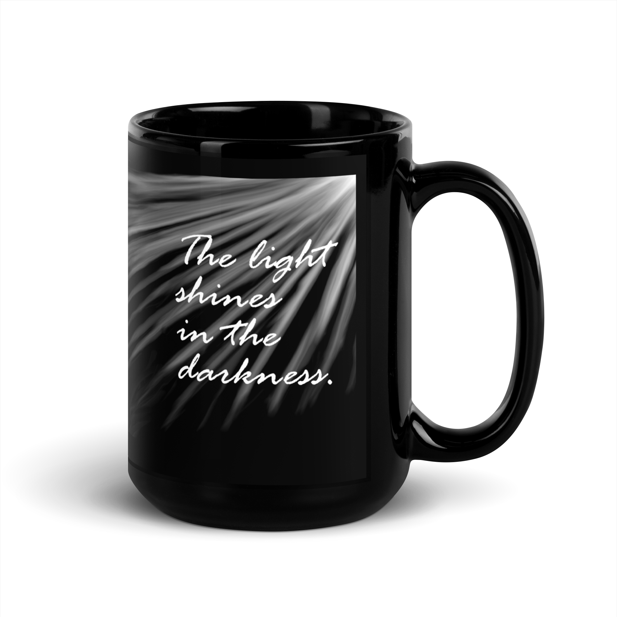 "The light shines..." black glossy mug, right-hand sunrays