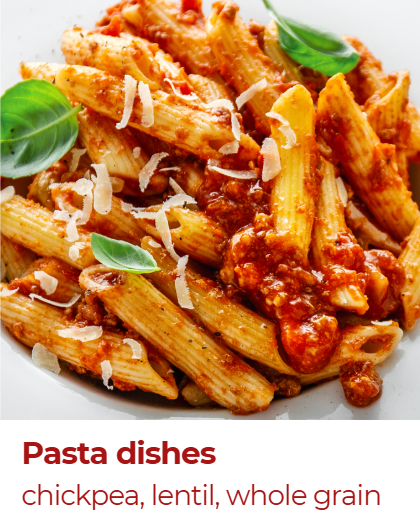 A bowl of cooked penne pasta with tomato sauce, garnished with basil leaves and grated cheese, served on a white plate.
