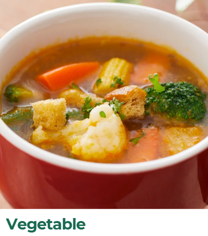 A bowl of vegetable soup with carrots, broccoli, cauliflower, corn, and croutons.