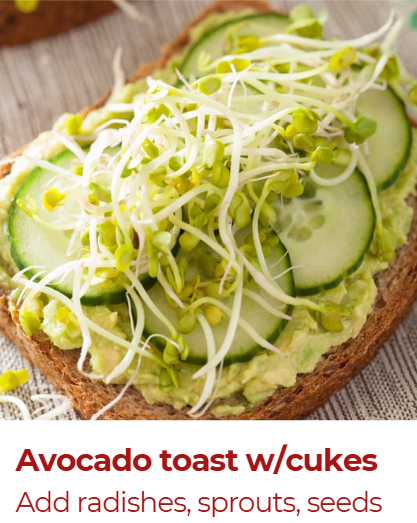 Close-up of avocado toast topped with sliced cucumbers, alfalfa sprouts, and seeds on whole-grain bread.