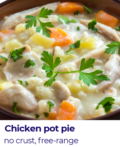 A chicken pot pie with a creamy filling containing chicken, carrots, potatoes, and peas, garnished with fresh parsley, served in a bowl.