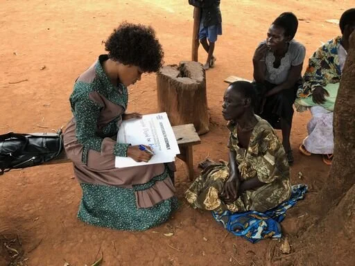 Mobilization_Uganda_Faridah surveying women in rural Uganda.jpeg