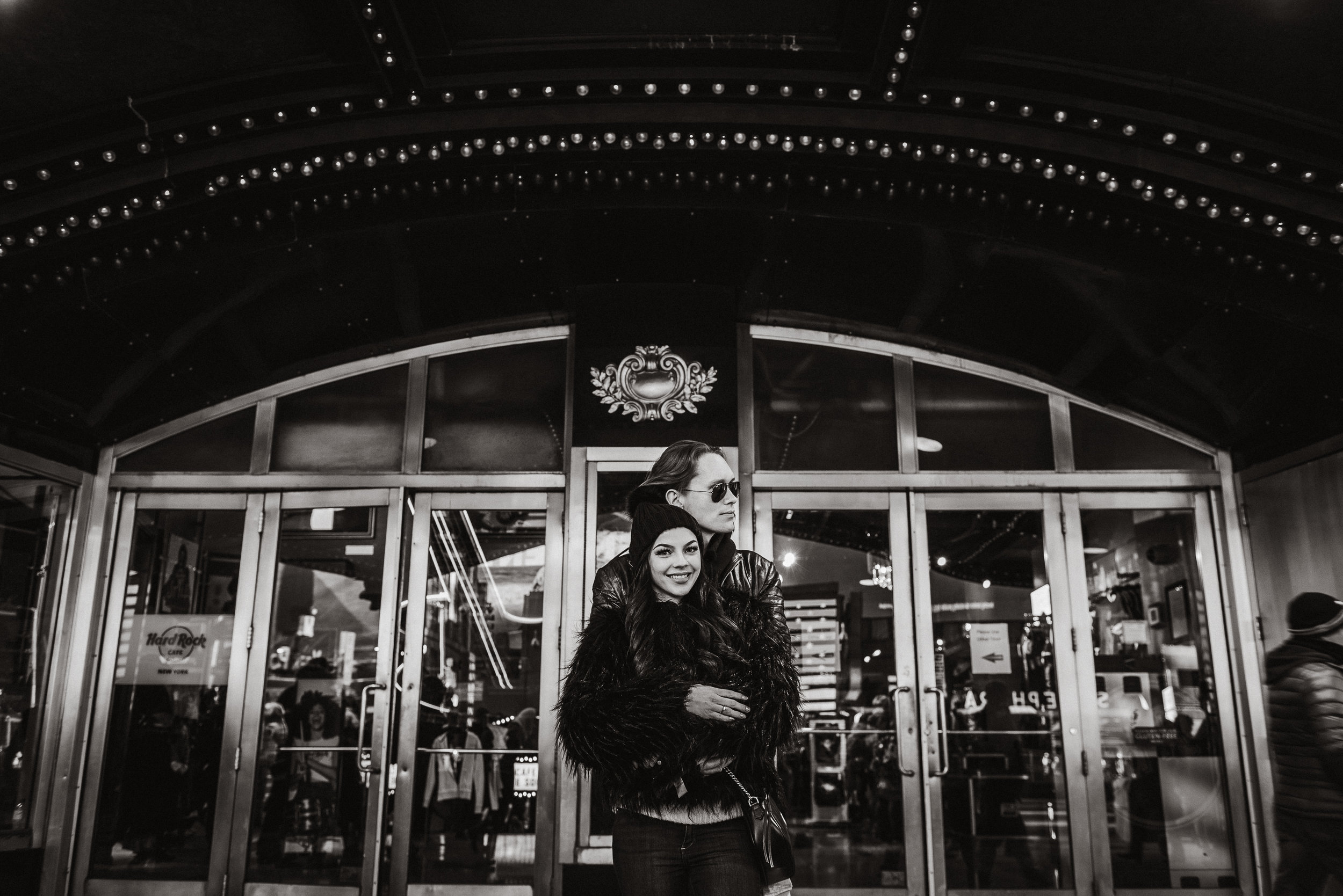 Couple kissing right in the middle of Times Square for their engagement and pre-wedding proposal photographs.