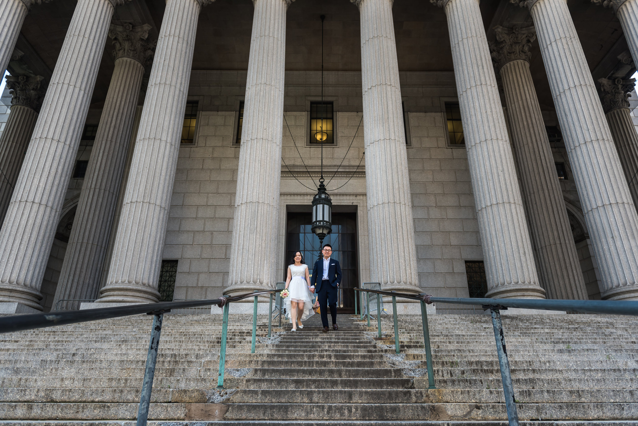 many and andy had a low key ceremony at city hall in manhattan, new york. Part of being a photojournalistic photographer is being able to set up natural looking photos that tell the story of their day. after the ceremony, we took some photos in the area as well as on the Brookyln Bridge