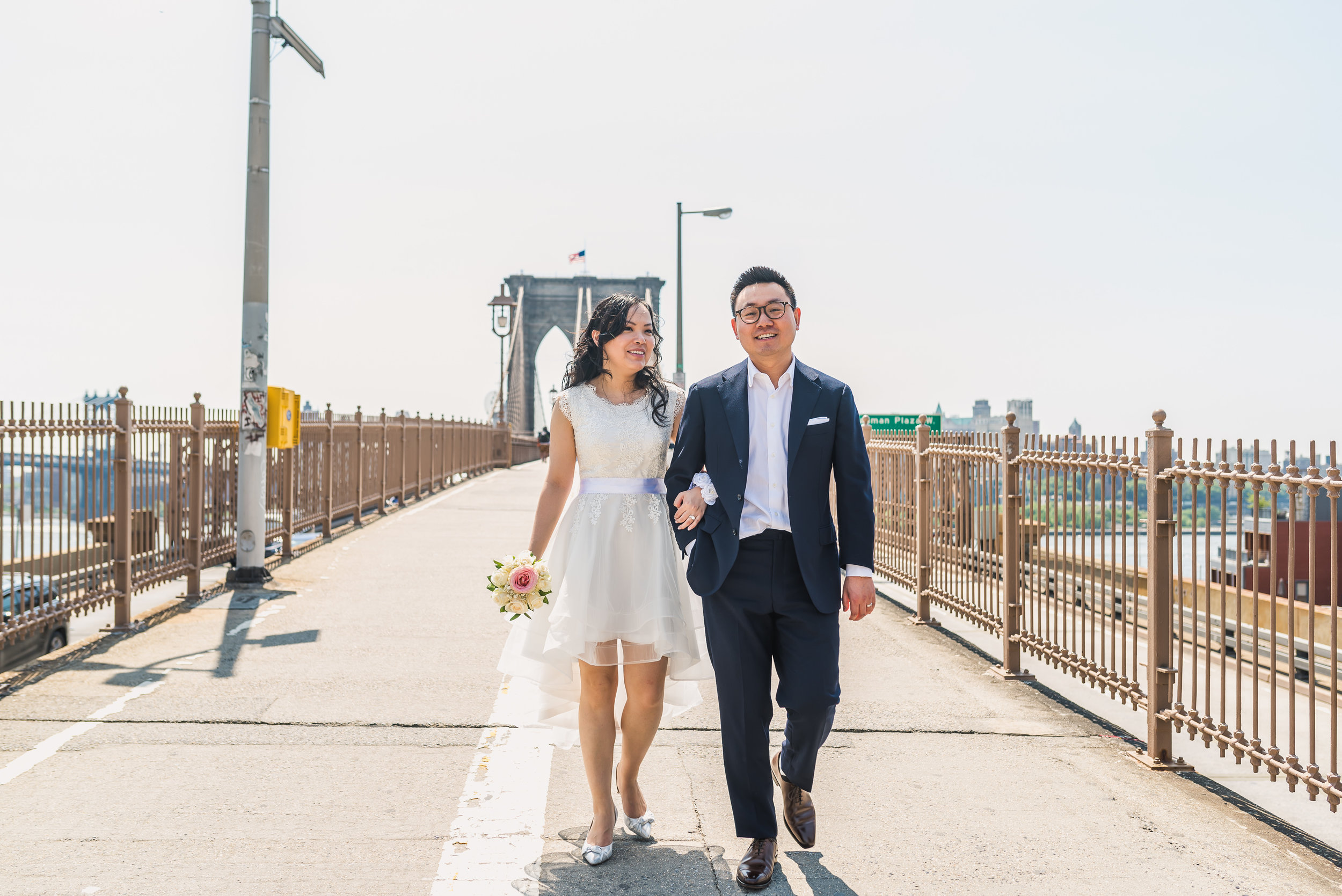 many and andy had a low key ceremony at city hall in manhattan, new york. Part of being a photojournalistic photographer is being able to set up natural looking photos that tell the story of their day. after the ceremony, we took some photos in the area as well as on the Brookyln Bridge