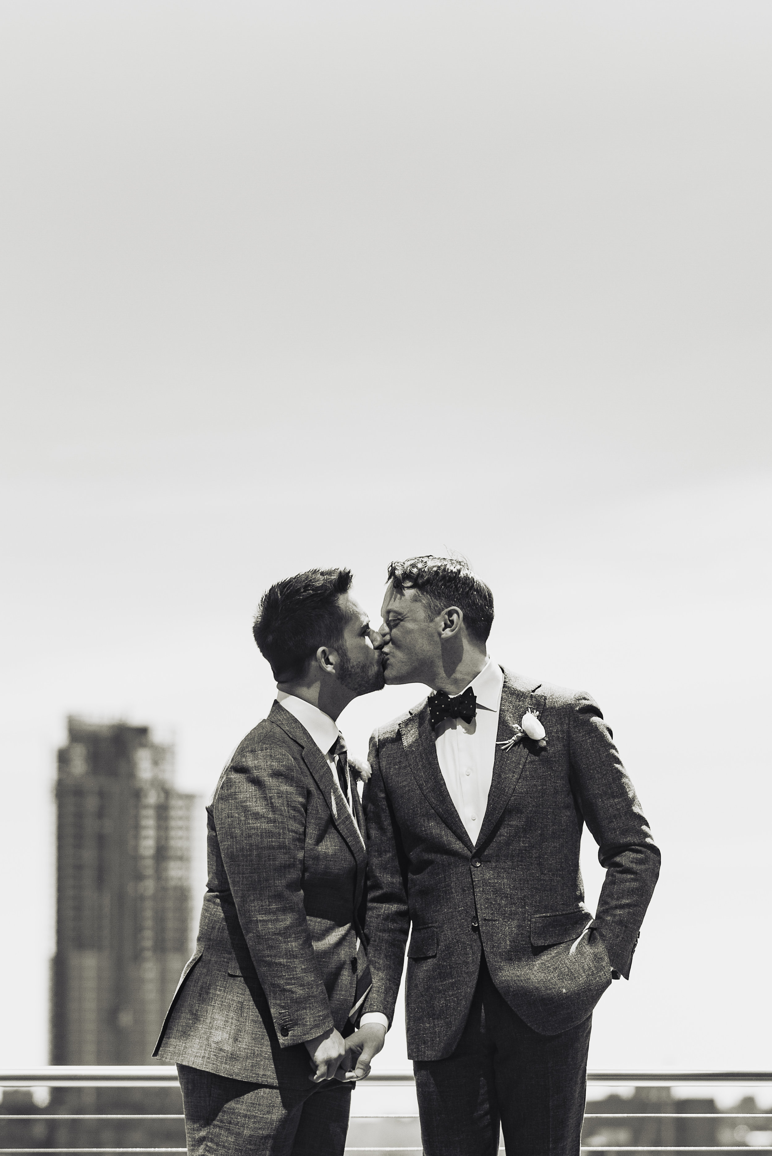 Two grooms kissing during their gay wedding at Riverpark Restaurant in NYC