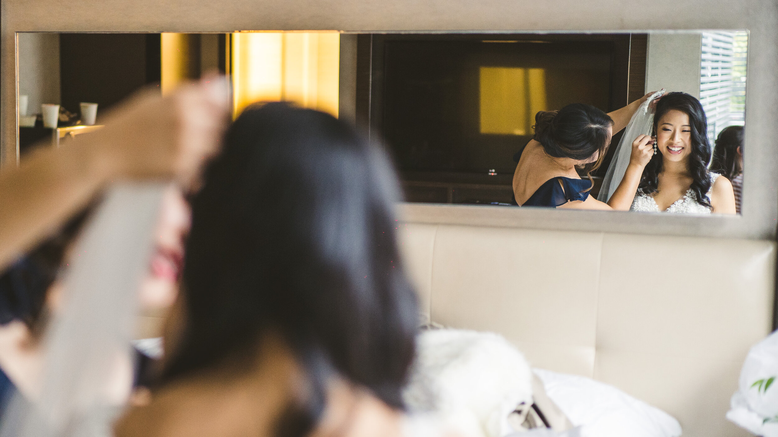 Creative angle of the bride getting her makeup done in DUMBO before her wedding at Bacchus in New York, New York