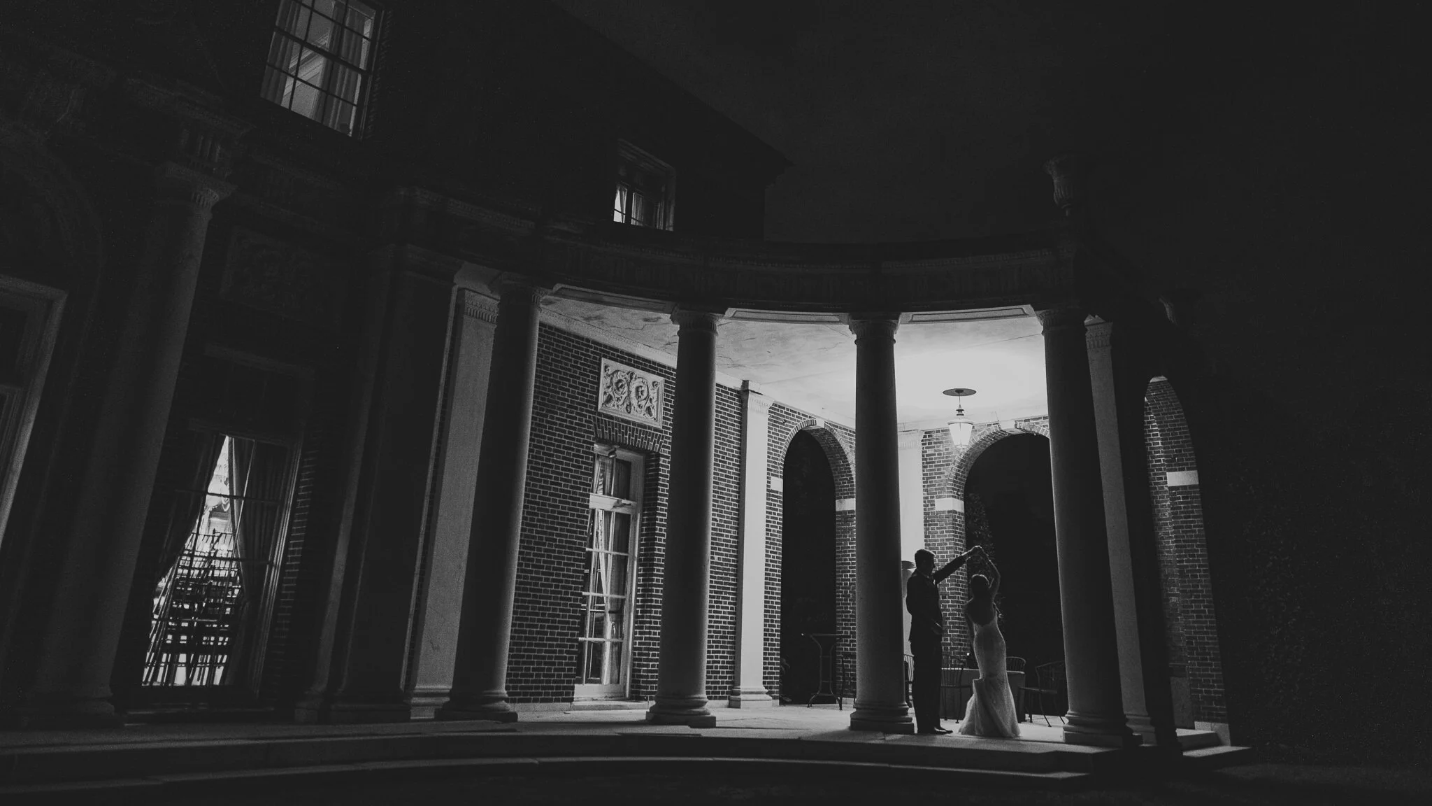 Night time portrait of the bride and groom dancing outside of the de Seversky Mansion in Long Island, New York